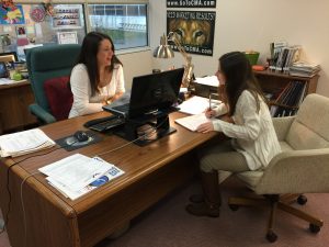 Alexandra Perrine, a Rider University marketing major from West Windsor, works with Erin Klebaur, director of marketing services, as she reports her findings after doing website evaluations as part of her internship at Creative Marketing Alliance.