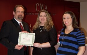 Kenneth Hitchner, public relations and social media director and fourth quarter Crew Star presents Victoria Hurley-Schubert, public relations account executive with the Crew Star award for the first quarter with Erin Klebaur, director of marketing services.