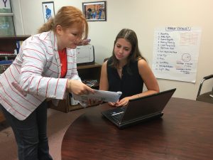 CMA Intern Jordannah Schreiber works with Gabrielle Copperwheat, director of operations on a marketing project.